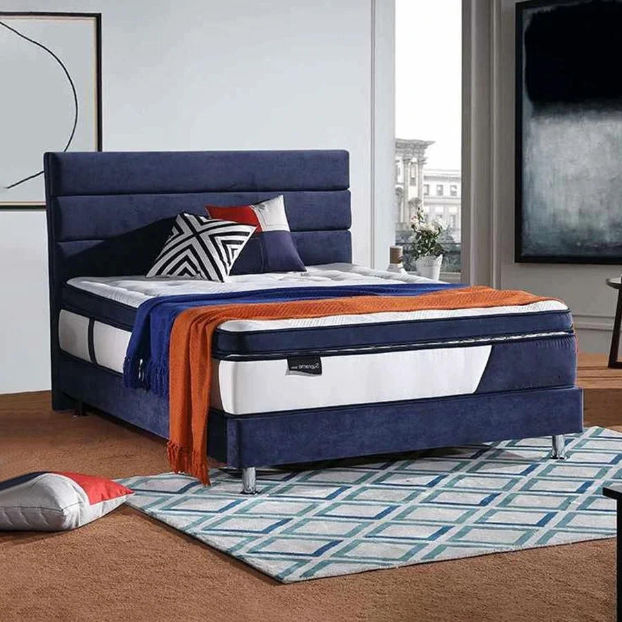Estructura de cama moderna azul con elegantes almohadas.