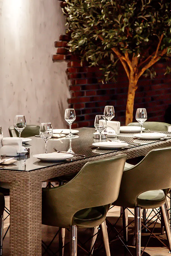 Conjunto de comedor moderno de ratán con sillas verdes.