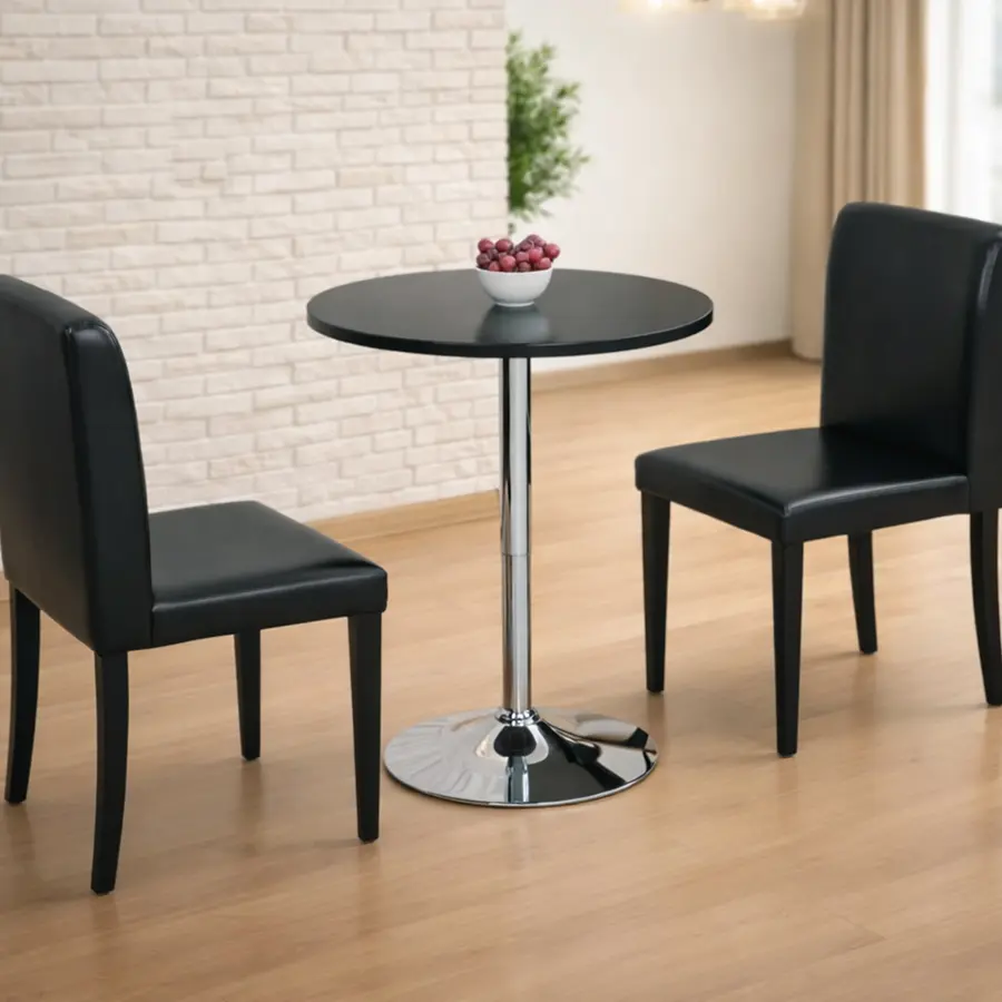 Mesa de comedor redonda moderna con dos sillas negras.